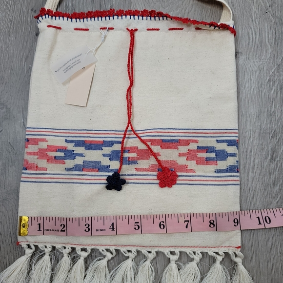 Boho fabric crossbody bag with knit string and flowers and fringe. 10"×9" - Picture 4 of 8